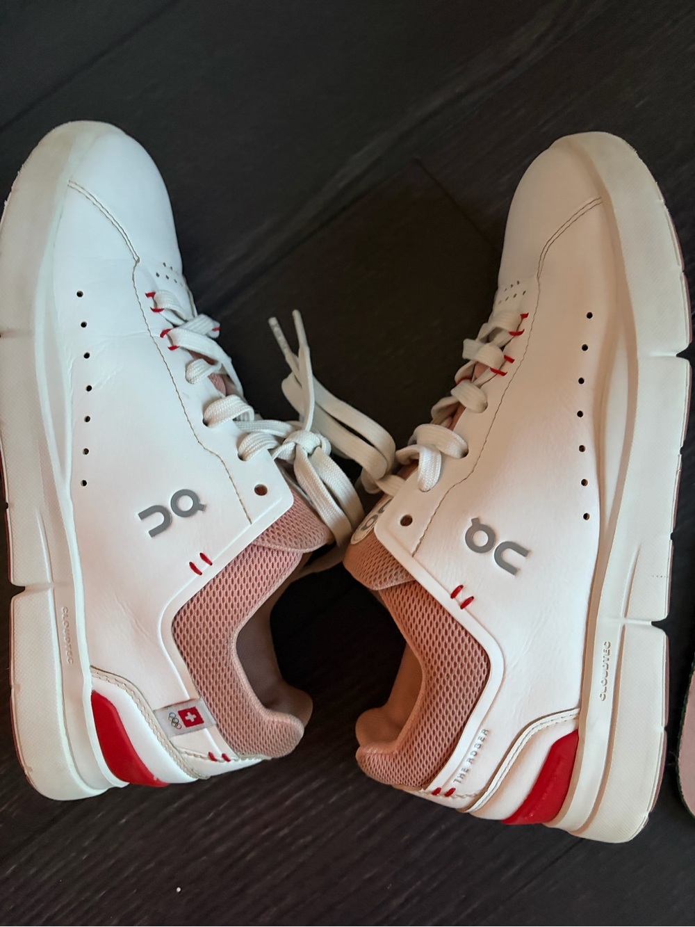 On Running White Sneakers with Blush and Red Accents On The Roger Advantage